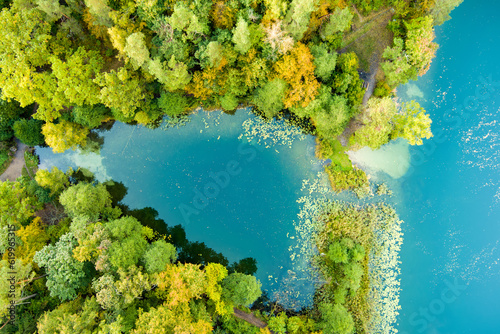 Aerial view of beautiful Balsys lake, one of six Green Lakes, located in Verkiai Regional Park. Birds eye view of scenic emerald lake surrounded by pine forests. Vilnius, Lithuania.