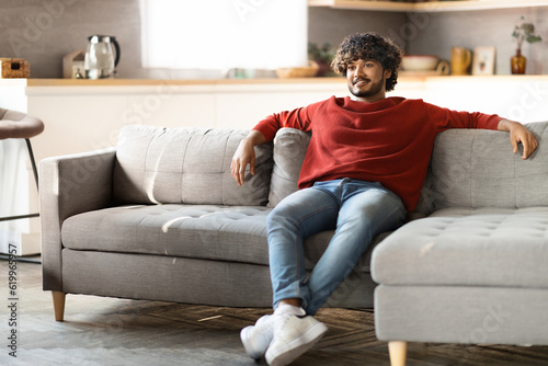 Lazy Weekend. Handsome Indian Guy Resting On Comfy Couch In Living Room © Prostock-studio