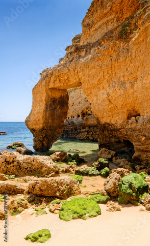 Natural arch and turquoise sea on a sunny day, beach Praia da Coelha, Algarve, Portugal © Weax