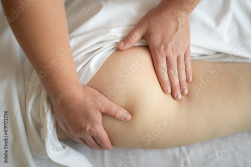 The masseur massages the buttocks, thigh and legs. Anti-cellulite massageon the hips and buttocks. Relaxing treatment