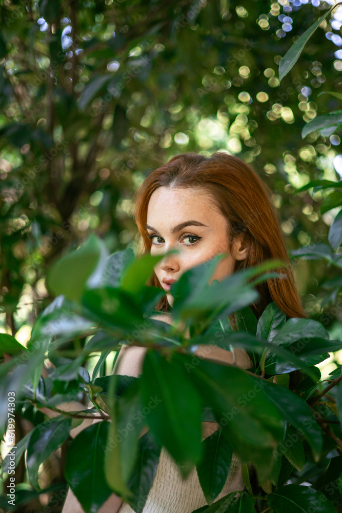 very beautiful freckled white woman with long red hair and make-up in a garden of green leaves in a garden of green leaves very beautiful freckled white woman with long red hair and make-up in a garden of green leaves in a garden of green leaves