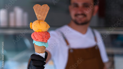 ice cream shop owner holding ice cream photo