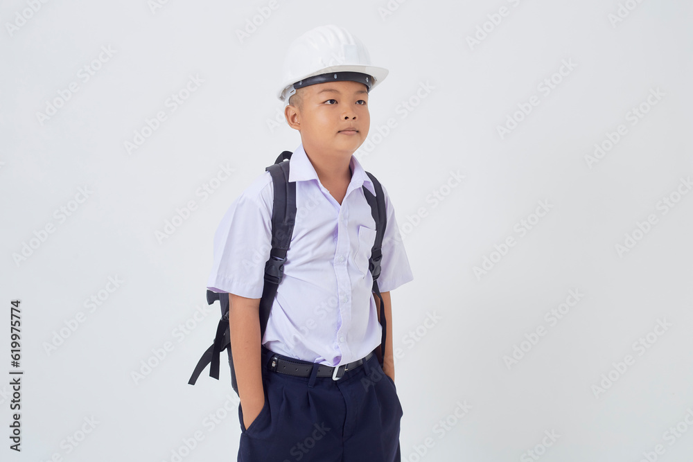 A young Asian cute boy standing in a Thai school uniform with a backpack bag and safety helmet on a white background banner A young Asian cute boy standing in a Thai school uniform with a backpack bag and safety helmet on a white background banner