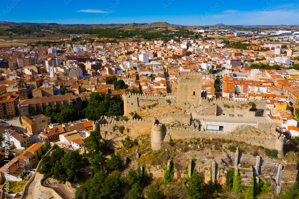 View from drone of historic center of Spanish city of Almansa overlooking ancient fortified Castle and bell-tower of Roman Catholic Church, province of Albacete