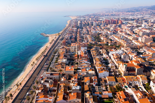 Picturesque drone view of modern Vilassar de Mar cityscape on Mediterranean coast on sunny winter day, Spain.. photo