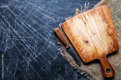 wooden Cutting board on dark backdrop Surface copy space for design text