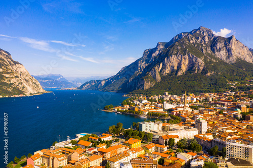 Colorful mountain scenery with Italian city of Lecco on shore of picturesque Lake Como on sunny day  Italy