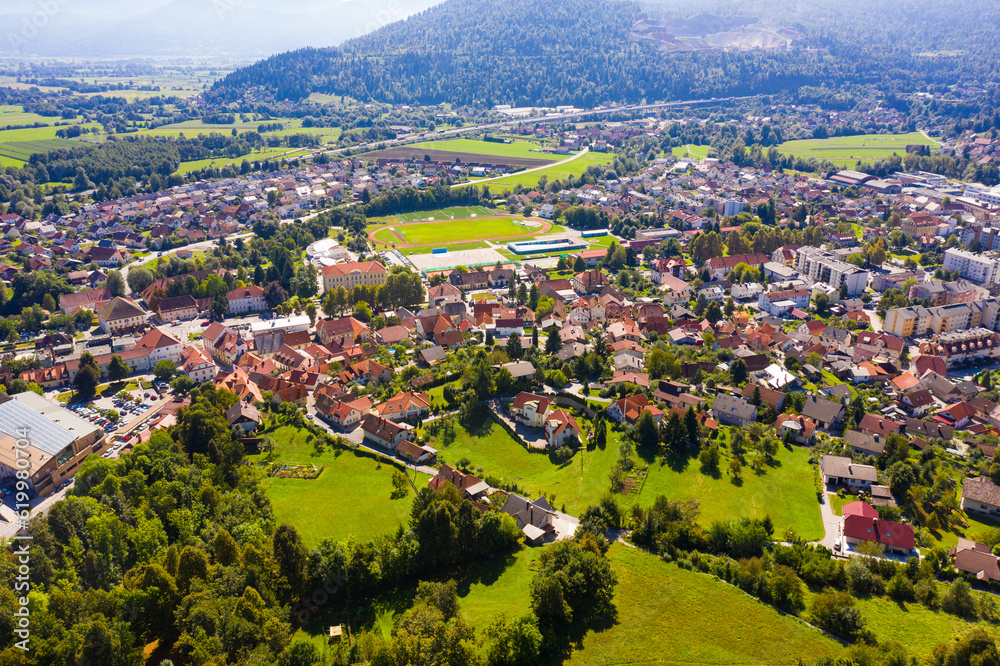 Scenic aerial view of Slovenian township of Vrhnika in valley between Ljubljana Hills in autumn day..