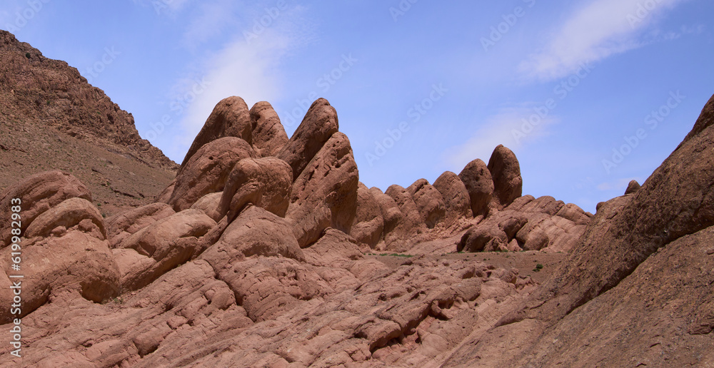 Rocky landscape of mountain ridge Monkey Fingers or Monkey paws in Dades gorge, Atlas Mountains. Rocks that look like fingers rising from the earth. Unique walking trail in oasis in Atlas Mountains.