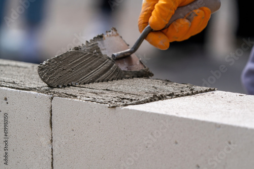 The bricklayer is working. Building a wall of aerated concrete. Gasbeton wall