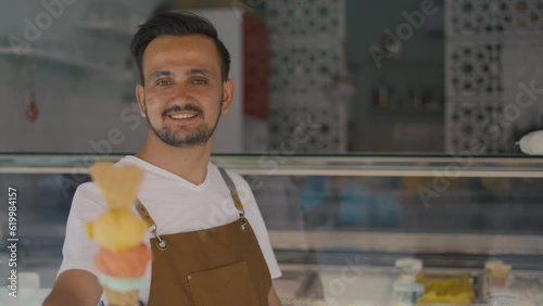ice cream shop owner holding ice cream