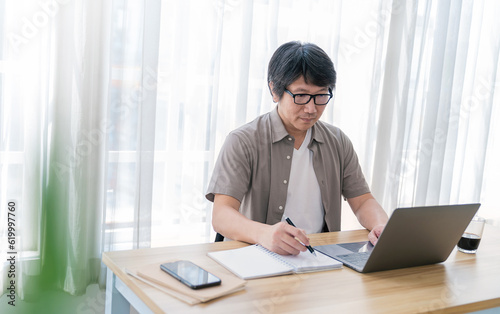 Portrait of smiling business asian senior middle age man working office desk virtual computer. Small business people employee freelance online sme marketing e-commerce telemarketing concept banner