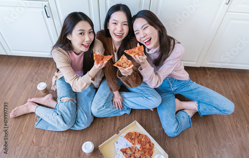 Portrait of  young mixed diverse friends eating ordered pizza in kitchen home party. Happy asian race young girl friends enjoyspending free weekend vacation time together. Fast delivery food concept #619997793