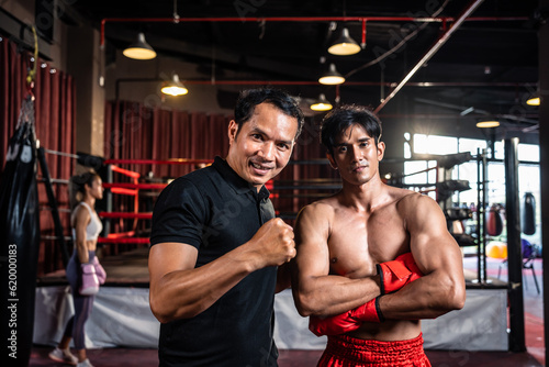 Portrait of Asian male referee and sportsman boxer in boxing stadium.  © Kawee