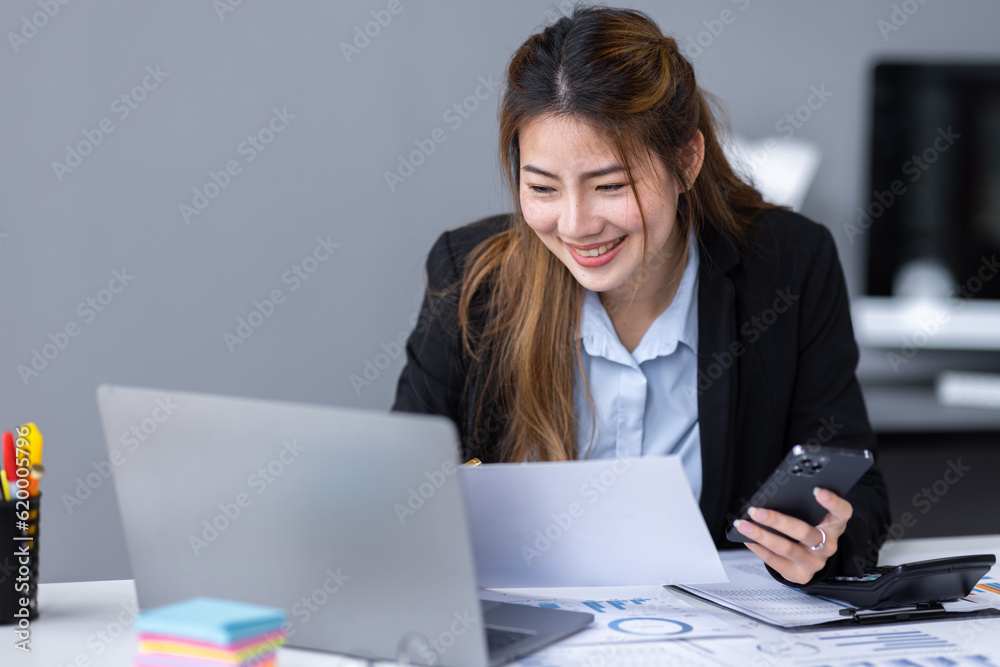 Thoughtful young asian woman entrepreneur holding smart phone and checking financial reports business plan investment, finance analysis concept Thoughtful young asian woman entrepreneur holding smart phone and checking financial reports business plan investment, finance analysis concept