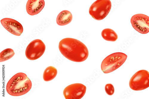 Falling fresh ripe tomatoes on white background.