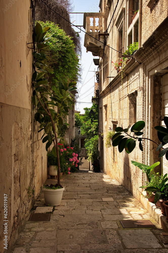 Narrow street of Korcula town in Croatia and a fragment of its architecture