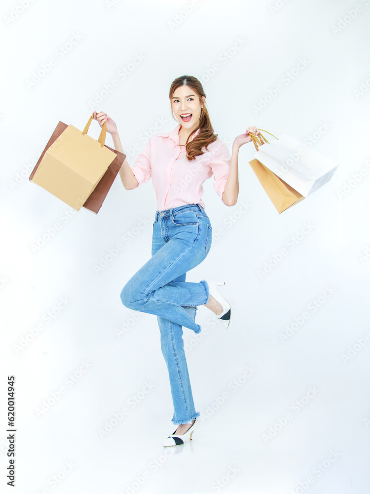 Portrait isolated cutout studio full body shot of Asian cheerful female clients customers shoppers in casual outfit buying holding paper shopping bags in department store on white background Portrait isolated cutout studio full body shot of Asian cheerful female clients customers shoppers in casual outfit buying holding paper shopping bags in department store on white background