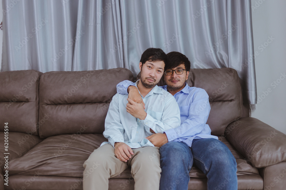 Young two man couple at modern home happy smiling have romantic time in living room at house.