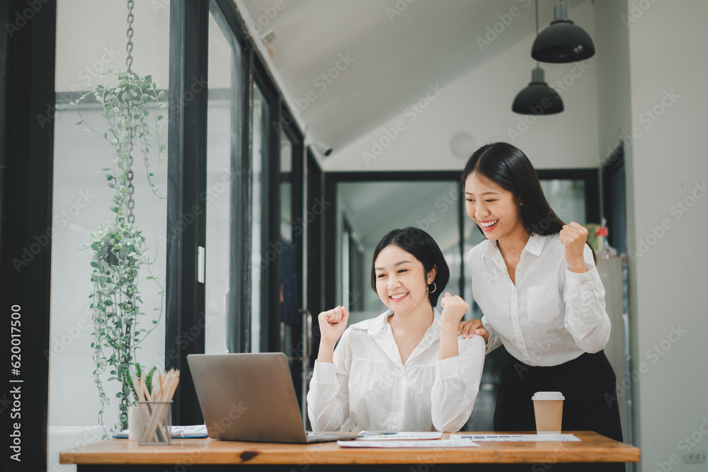 Beautiful two asian girl celebrate with laptop, success happy pose, E-commerce, university education, internet technology, or startup small business concept. Beautiful two asian girl celebrate with laptop, success happy pose, E-commerce, university education, internet technology, or startup small business concept.