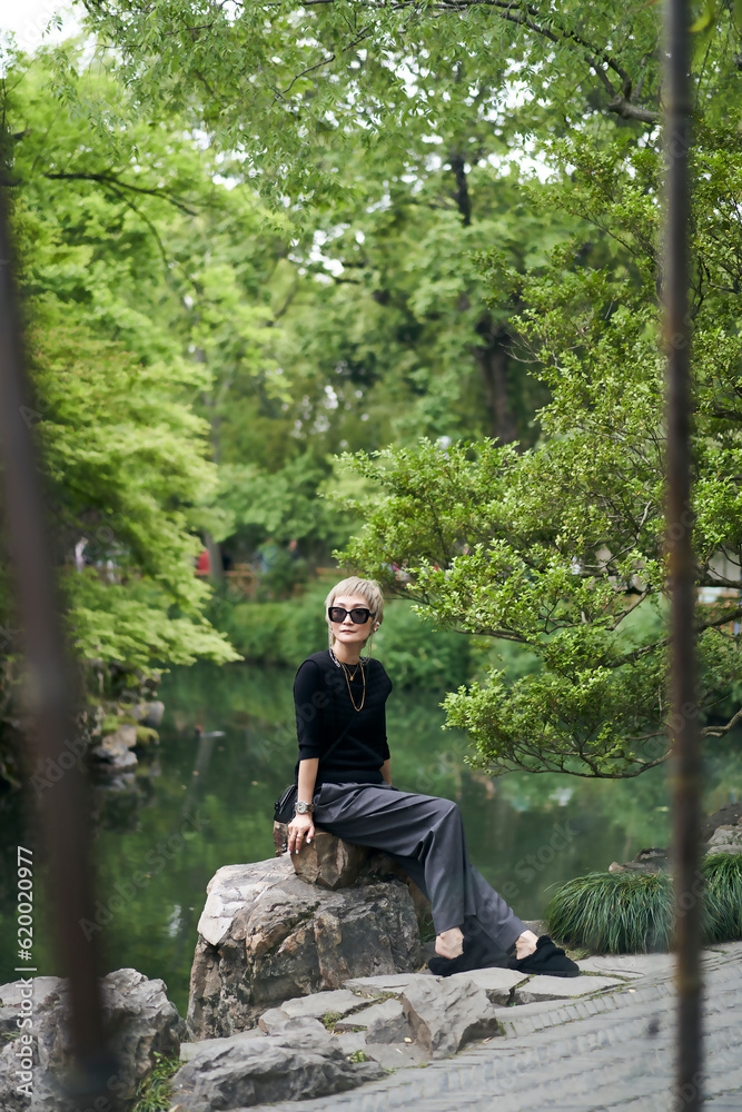 Asian beauty traveling in oriental garden in Spring during vacation Asian beauty traveling in oriental garden in Spring during vacation