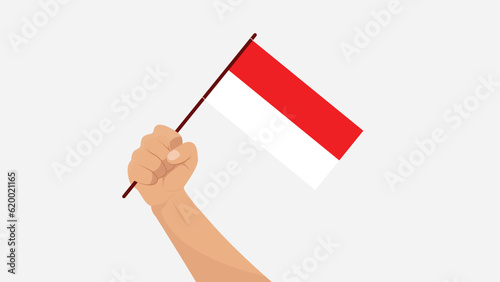 Hand holding Indonesian national flag isolated on white background, Indonesian independence day