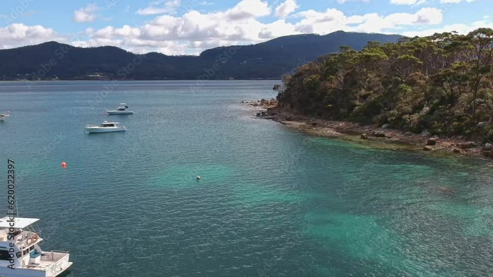 Aerial reveal of boats and rocky shoreline of Pirates Bay in Tasmania Aerial reveal of boats and rocky shoreline of Pirates Bay in Tasmania