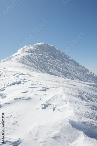Summit of snow covered mountain on a blue sky sunny day, Niseko, Hokkaido, Japan