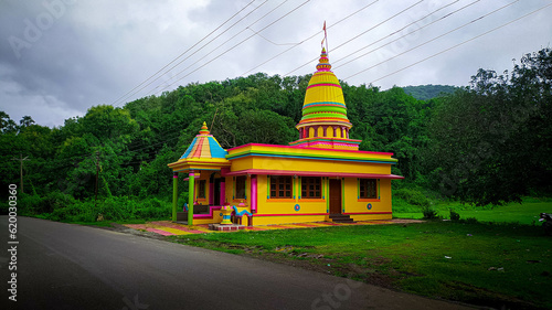 Colourful temple with green background in India. photo
