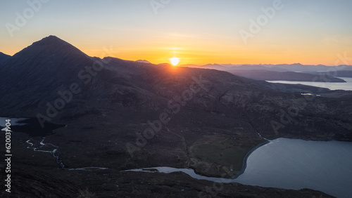 Aerial view of a sunset over the Scottish mountains from the Isle of Skye, Scotland.
