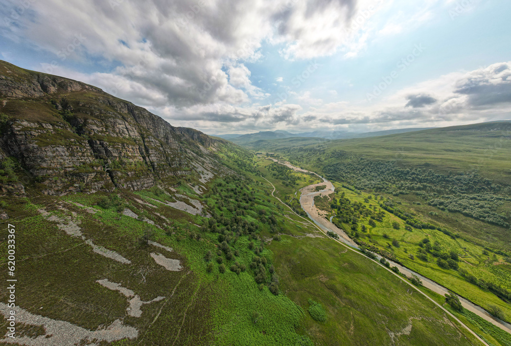 Aerial view of the Riddoroch Valley near Ullapool, showcasing the vast wilderness under a cloudy summer sky.