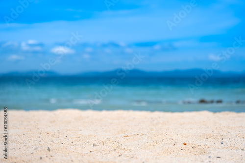 Beach sand background for summer vacation concept. Beach nature and summer seawater with sunlight light sandy beach Sparkling sea water contrast with the blue sky. © Photo Sesaon