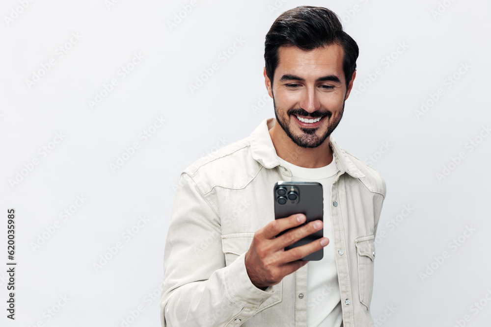 Close-up portrait man holding a phone smile typing a message, chatting online freelance work on a white isolated background, fashionable clothing style, copy space, space for text Close-up portrait man holding a phone smile typing a message, chatting online freelance work on a white isolated background, fashionable clothing style, copy space, space for text
