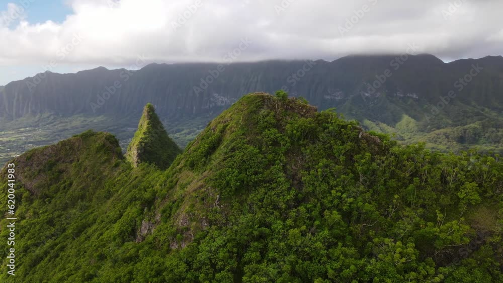 Aerial view of the Olomana Three Peaks Hiking Trail in the mountain range in Oahu, Hawaii, Olomana, Paku'i and Ahiki hills Aerial view of the Olomana Three Peaks Hiking Trail in the mountain range in Oahu, Hawaii, Olomana, Paku'i and Ahiki hills