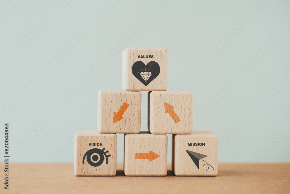 For mission vision values concept icon and arrow on wooden cubes stacked , including copy space. Banner to communicate organization to identify business policy and direction For mission vision values concept icon and arrow on wooden cubes stacked , including copy space. Banner to communicate organization to identify business policy and direction