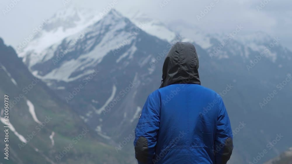 Rear view of Indian tourist man wearing hooded winter jacket and looking at snow capped mountains at Rohtang Pass, Himachal Pradesh, India. People enjoying vacation. Winter background for travel.
Rear view of Indian tourist man wearing hooded winter jacket and looking at snow capped mountains at Rohtang Pass, Himachal Pradesh, India. People enjoying vacation. Winter background for travel.