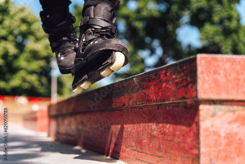 Canvas Print aggressive roller skater performing a trick on a railing in skatepark