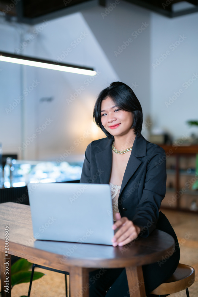 Portrait of asian freelance people businesswoman casual working with laptop computer in cafe interior in coffee shop background,business expressed confidence embolden and successful concept