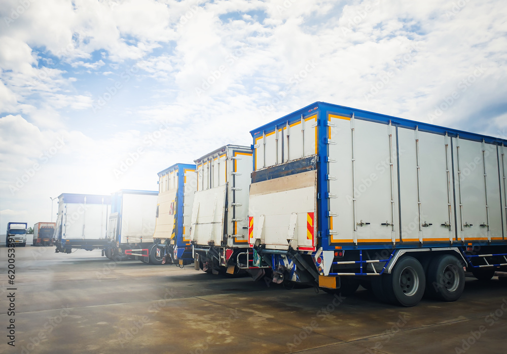 Row of Cargo Container Trucks on The Parking Lot. Lifting Ramp Trucks. Commercial Transport Lorry, Distribution Warehouse Shipping. Freight Truck Logistic, Cargo Transport.