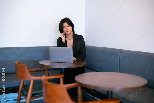 Portrait of asian freelance people businesswoman casual working with laptop computer in cafe interior in coffee shop background,business expressed confidence embolden and successful concept