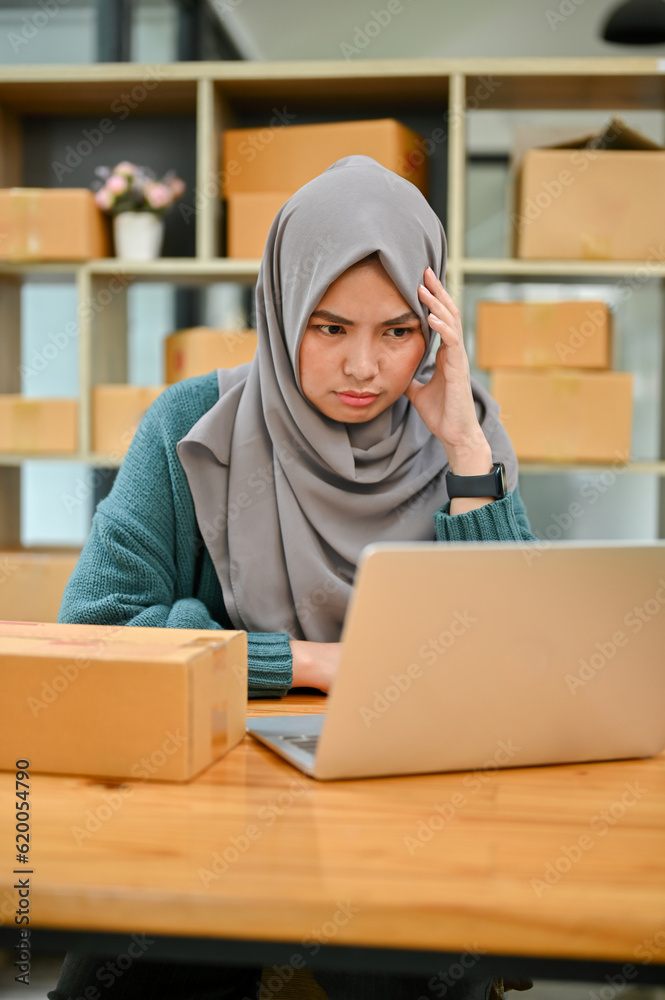 Stressed Muslim online business owner feeling upset and unhappy about the sale and orders Stressed Muslim online business owner feeling upset and unhappy about the sale and orders