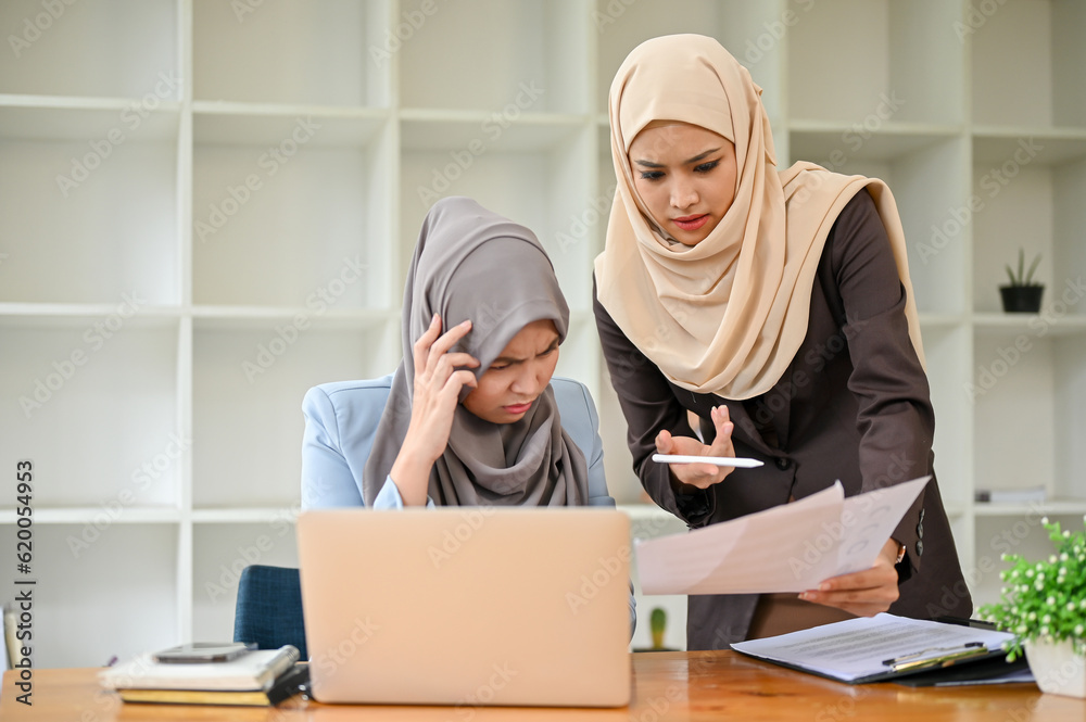 Professional Muslim business team working together, discussing on project in the office room. Professional Muslim business team working together, discussing on project in the office room.