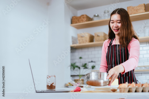 Streaming Culinary, Woman Making and Decorating a Cake in the Kitchen, Connected through Laptop