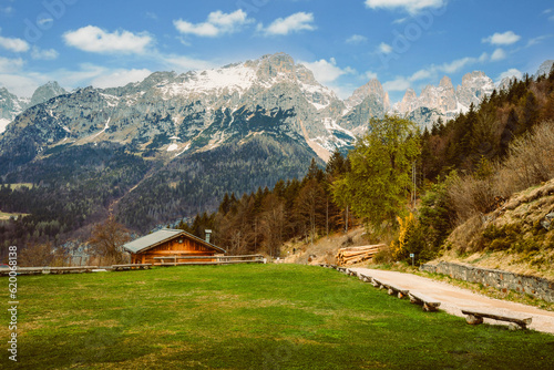 Brenta Dolomites from Pradel Plateau with typical mountain wooden house