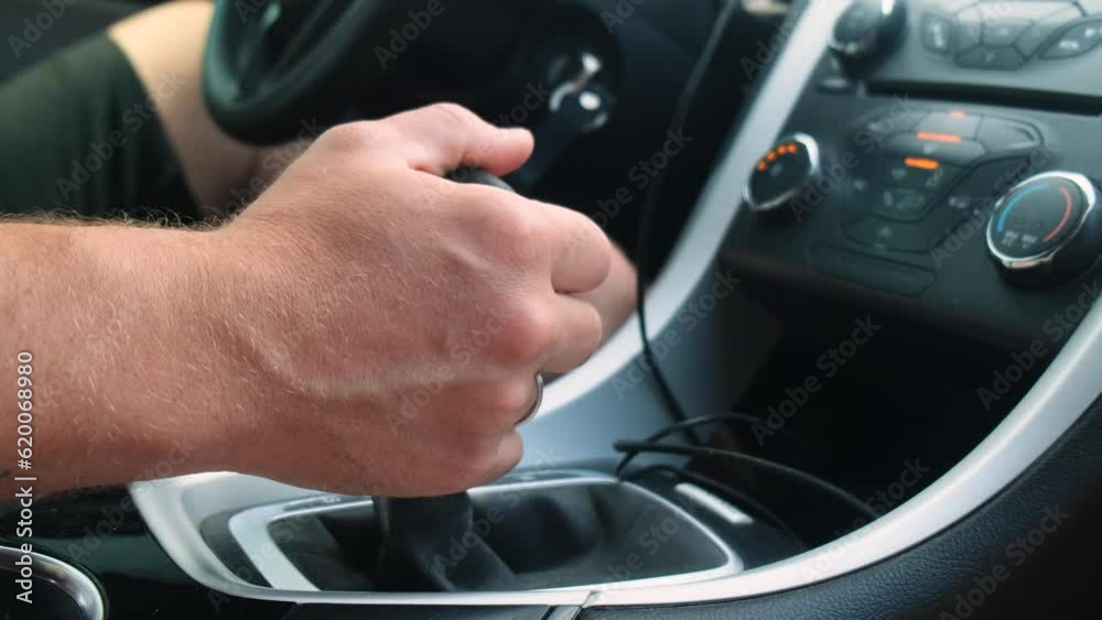The male driver switches the automatic transmission in the car. Close-up. The male driver switches the automatic transmission in the car. Close-up.