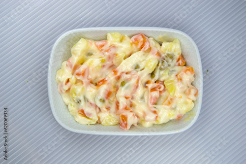 Russian salad made with carrots, potatoes, peas and mayonnaise