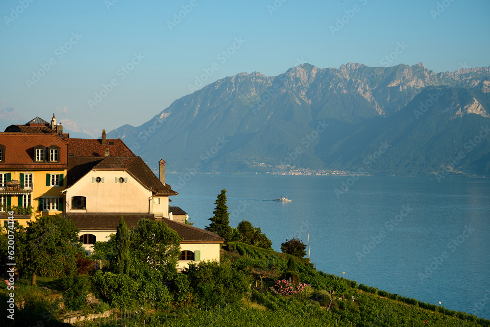Village in Switzerland by lake and mountains in sunset Village in Switzerland by lake and mountains in sunset