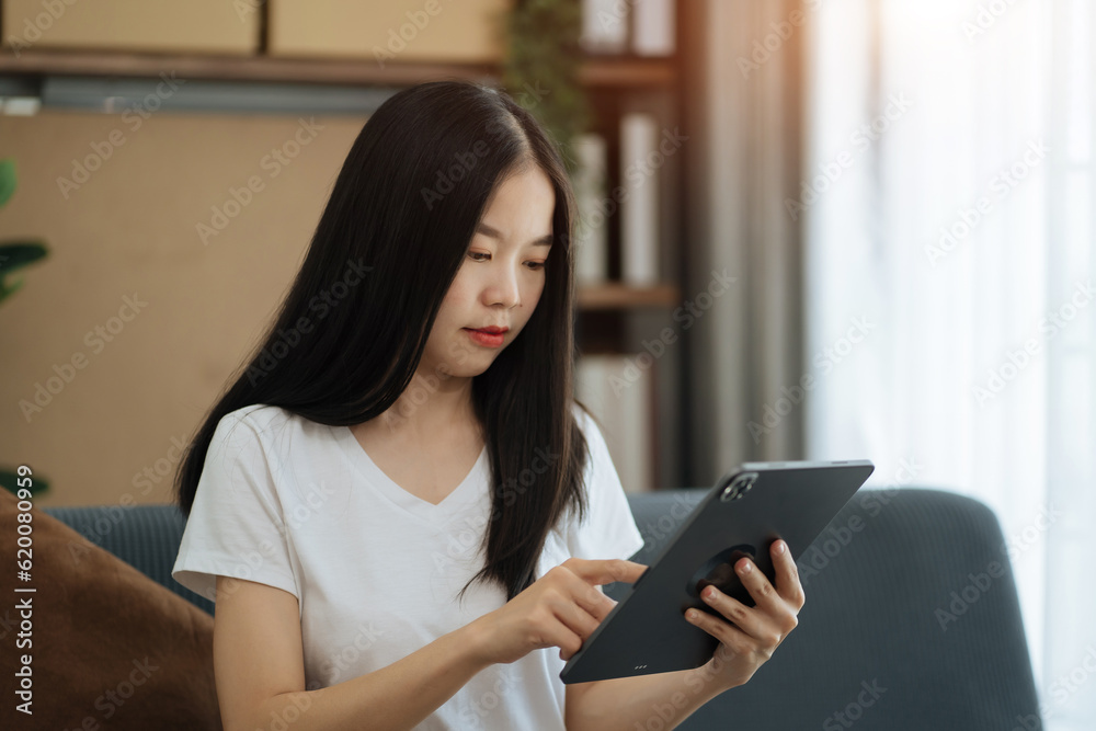 lifestyle of home office workers Woman sitting on sofa and using smartphone, laptop. Home office. Work place. Lifestyle. lifestyle of home office workers Woman sitting on sofa and using smartphone, laptop. Home office. Work place. Lifestyle.