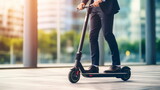 Young business man in a suit riding an electric scooter on a business meeting. Transportation environmental concept.
