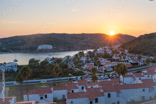Sunset over the bay of Playa de Fornells in Menorca Spain. 